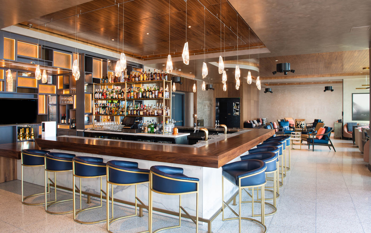 a bar with blue stools and a counter